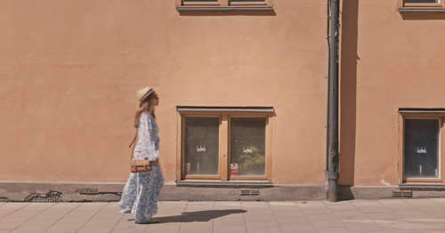 Mira walking along a sunlit street